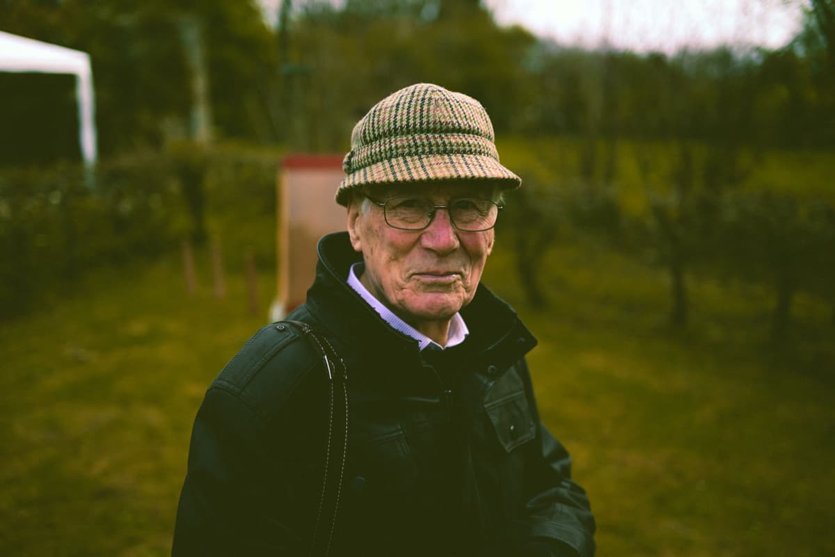 black and white portrait, elderly man, textured wall, timeless